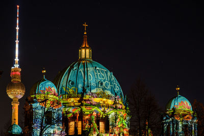 Illuminated building against sky at night