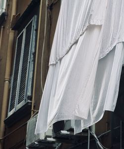 Low angle view of clothes drying against building