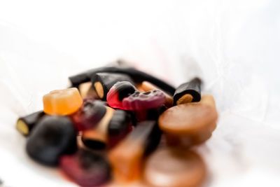 Close-up of candies on table against white background