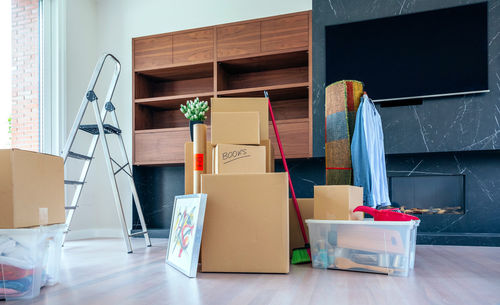 Cardboard boxes and ladder in new home