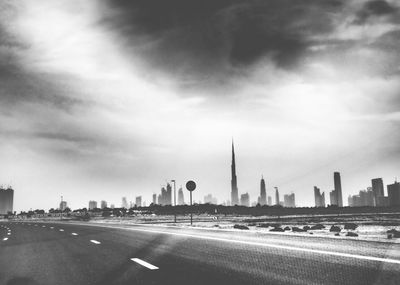 City street against cloudy sky