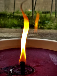 Close-up of lit candle on water