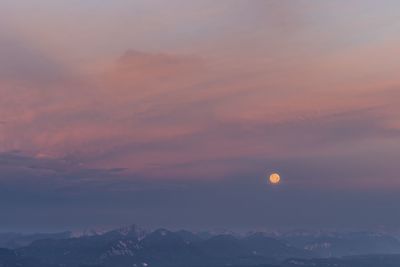 Scenic view of mountains against sky at sunset