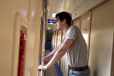 Man travels alone by train and looks out