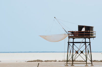 Lifeguard hut on beach against clear sky