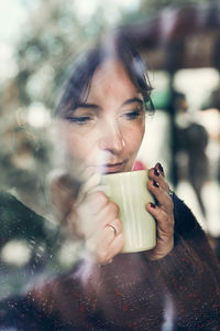 Thoughtful woman drinking coffee