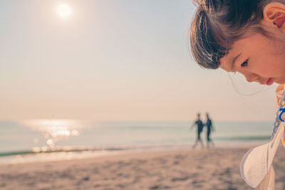 Woman at beach against sky