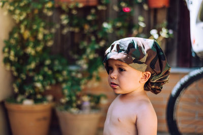 Portrait of shirtless boy looking away