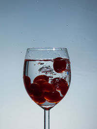 Close-up of wine glass against blue background