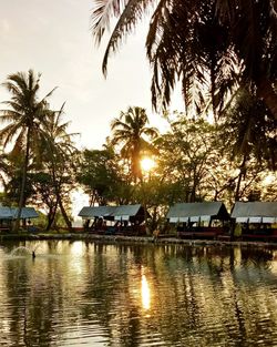 Scenic view of river against sky at sunset