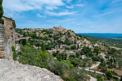 High angle view of townscape by sea against sky