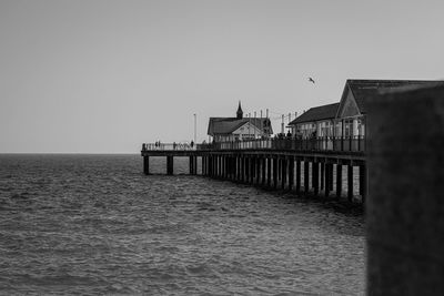 Building by sea against clear sky