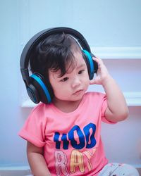 Portrait of cute girl using headphones