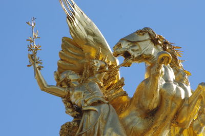 Low angle view of statue against clear blue sky