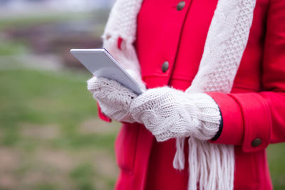 Close-up of woman holding mobile phone
