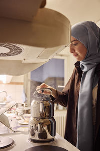 Woman preparing evening tea at home