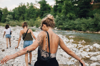 Rear view of women standing on beach
