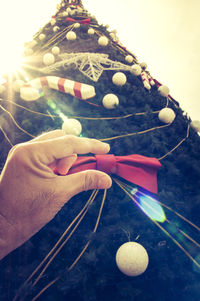 Close-up of hand holding christmas decoration