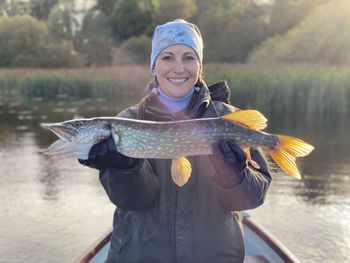 Portrait of young woman holding fish