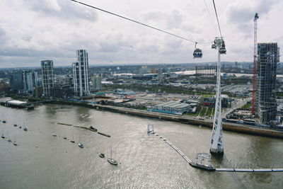 High angle view of river amidst buildings against sky