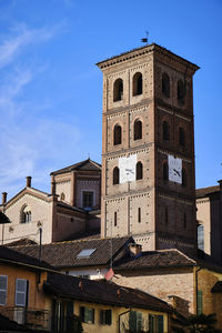 Low angle view of buildings against blue sky