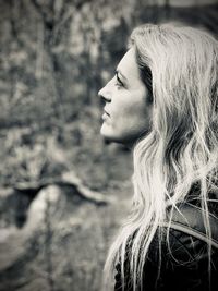 Side view of woman looking away in forest