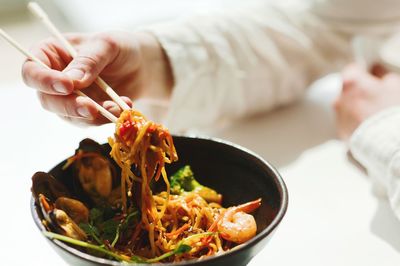 Midsection of person holding food in restaurant