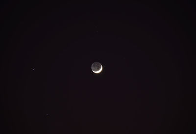 Low angle view of moon against sky at night