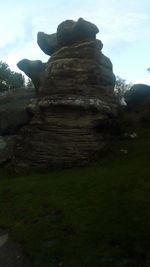 Rock formations on landscape against sky