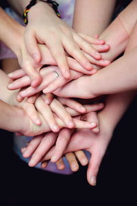 Cropped image of people stacking hands