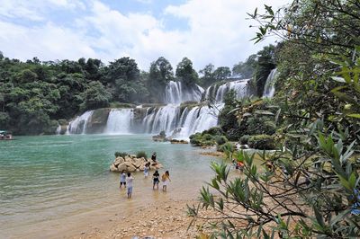 Scenic view of waterfall against sky