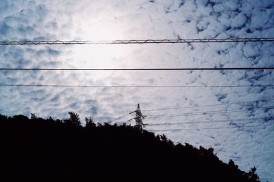 Low angle view of silhouette trees against sky
