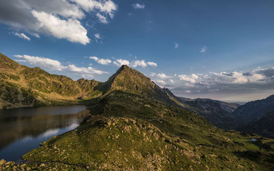 Scenic view of lake and mountains against sky