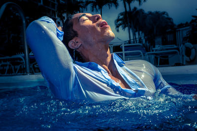 Young man swimming in pool