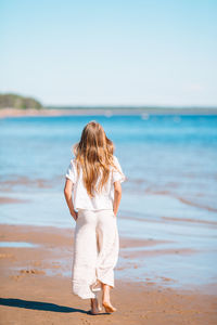 Rear view of woman standing on beach