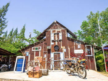 Bicycle by building against sky