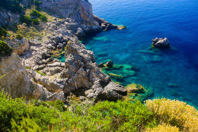 High angle view of rocks on sea shore