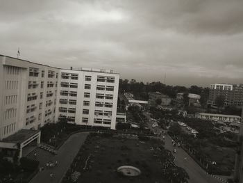 View of cityscape against cloudy sky