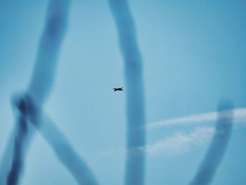 Low angle view of airplane flying against clear sky