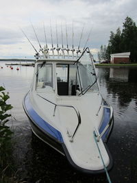 Boat moored on shore against sky