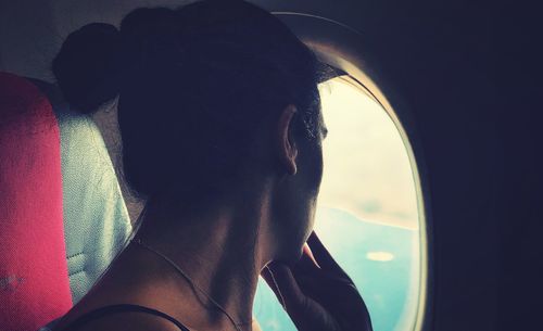 Close-up portrait of woman with reflection in mirror