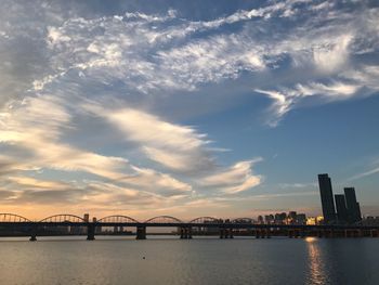 View of bridge over river against cloudy sky