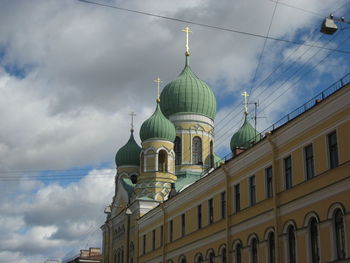 Low angle view of building against cloudy sky