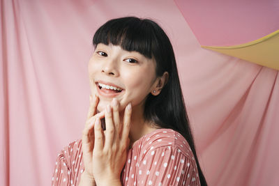 Portrait of smiling young woman looking away