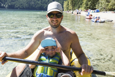 Father and son enjoying a beach day in their inflatable kayak