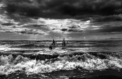 Scenic view of sea against cloudy sky