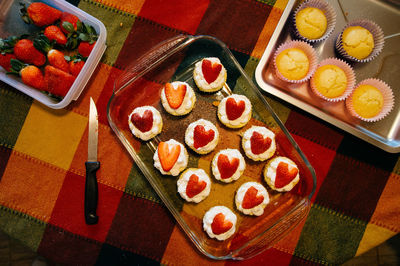 High angle view of strawberry cupcakes on table