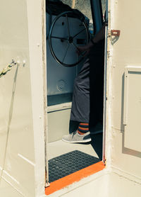 Low section of man working on door