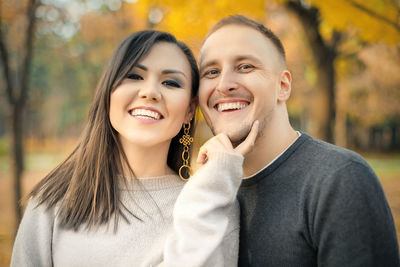 Happy couple standing in park