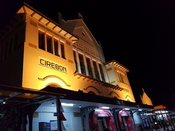 Low angle view of illuminated building against sky at night